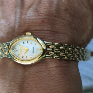 Elgin gold-tone wristwatch with a mother-of-pearl dial and diamond